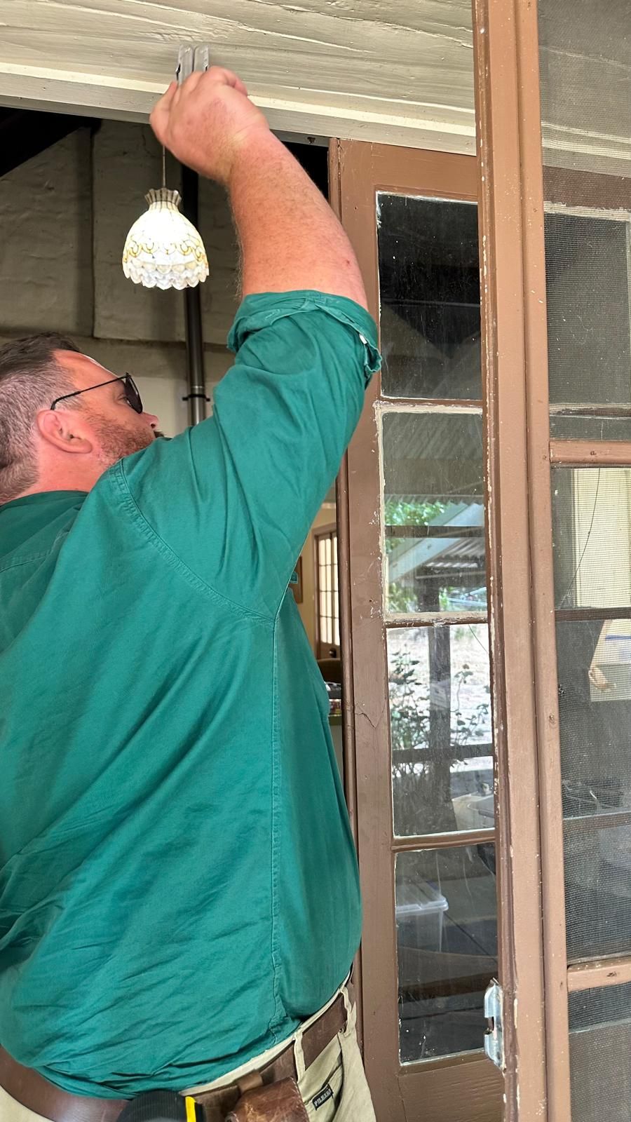 Expert glazier performing a precise window glass replacement and seal installation.