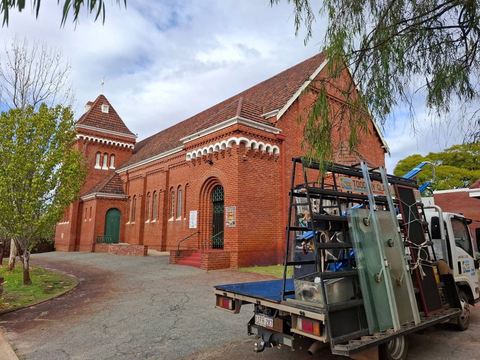 Specialised ecclesiastical glazing and glass maintenance for a historic brick church.