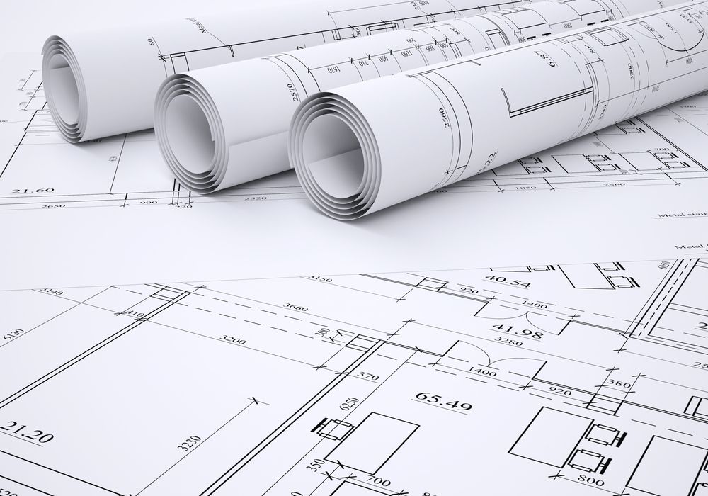 Rolled Up Architectural Blueprints on Top of an Open Blueprint Plan — Mid North Coast Drafting & Construction in Diamond Beach, NSW