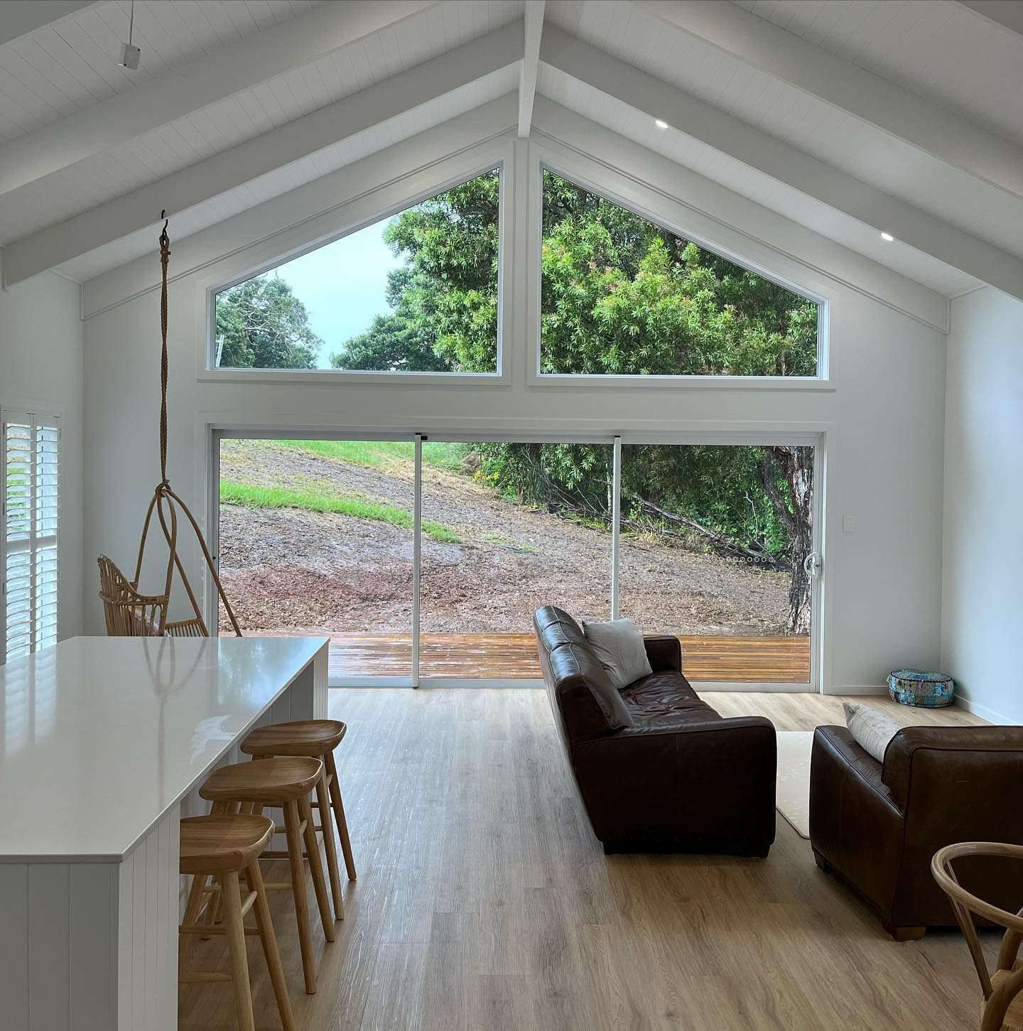 Bright high-ceiling living room in a modern home designed by a Builder Taree service in Taree, NSW.