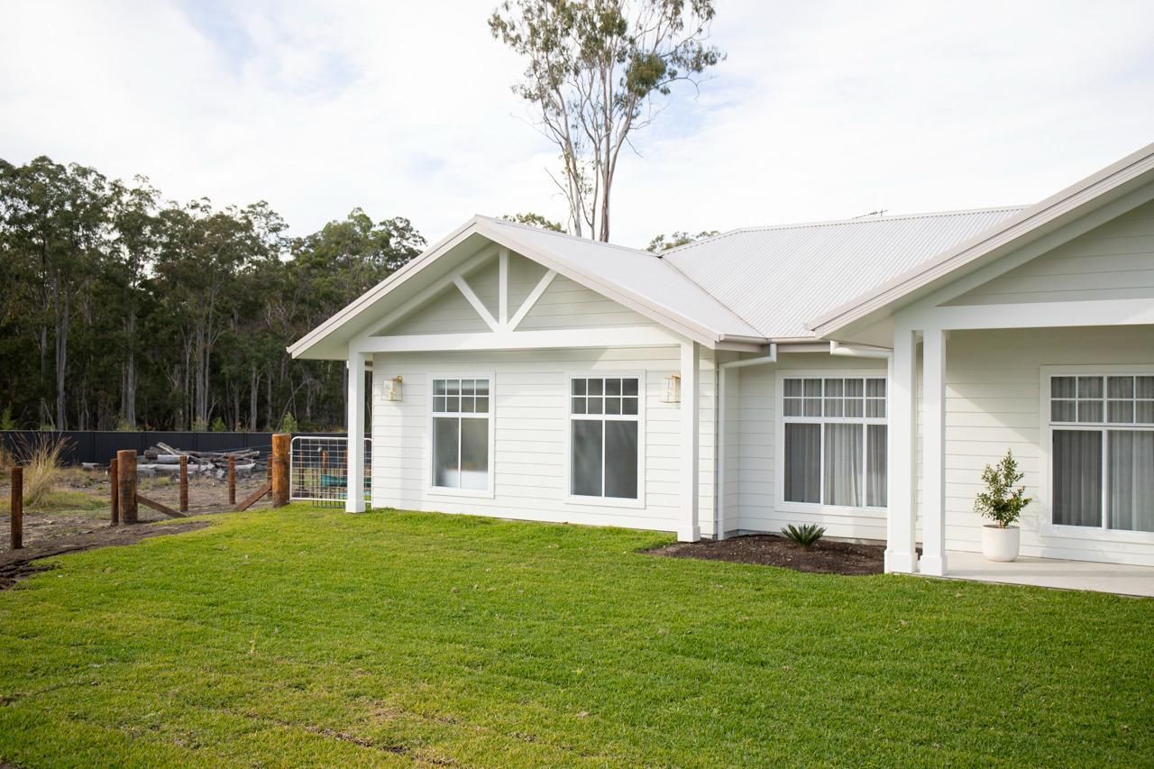 White House With Green Lawn and Trees — Mid North Coast Drafting & Construction in Taree, NSW