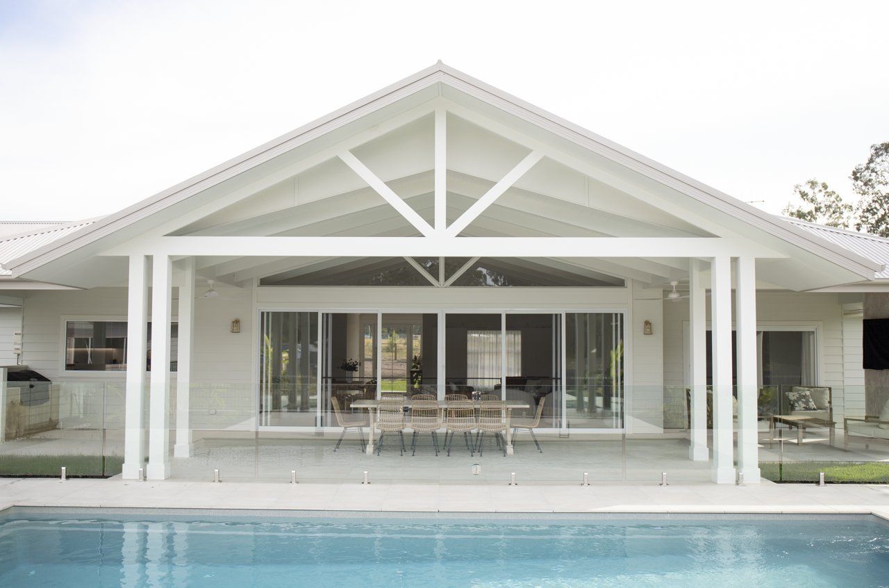 White House With Pool, Patio, and Glass Sliding Doors — Mid North Coast Drafting & Construction in Taree, NSW