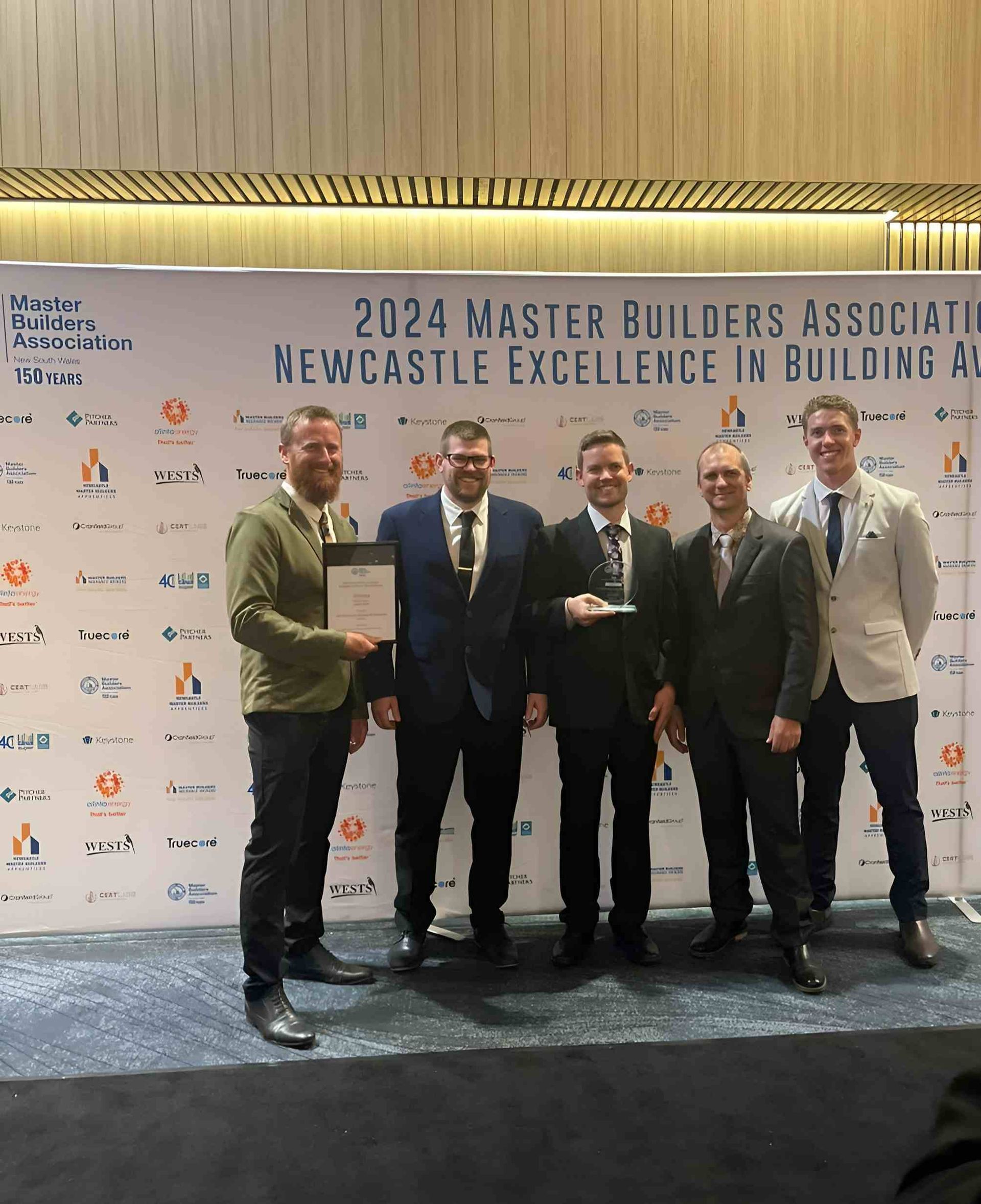 Group of Five Men With Award at 2024 Master Builders Event — Mid North Coast Drafting & Construction in Taree, NSW