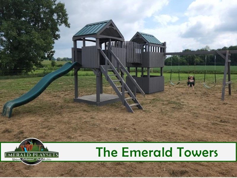 The emerald towers playground with a slide and swings