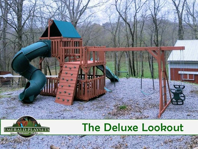 A deluxe lookout playground with a green slide and swings