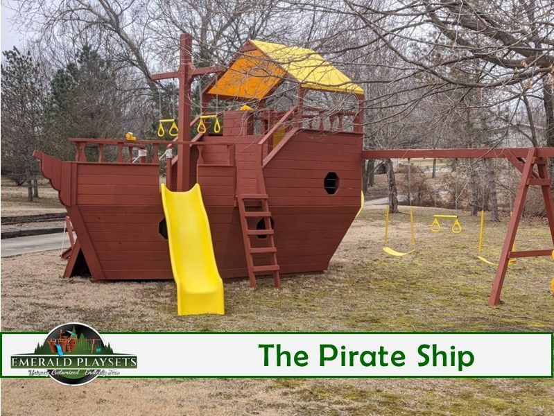 A wooden playground in the shape of a pirate ship