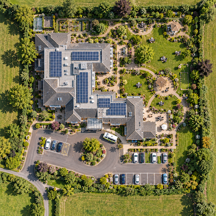 Modern multi-storey occupied building exterior, illustrating the type of continuously occupied premises a solar installation needs to work around