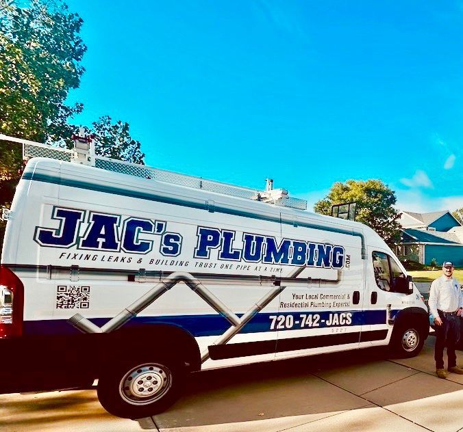 JAC’s Plumbing service van parked in a driveway under a bright blue sky