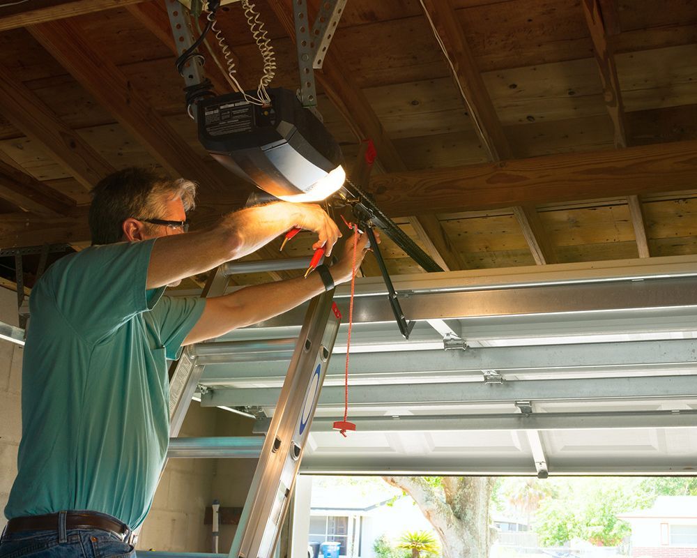 A man performing garage door cable repair in Oahu, HI, ensuring the door functions properly and safe