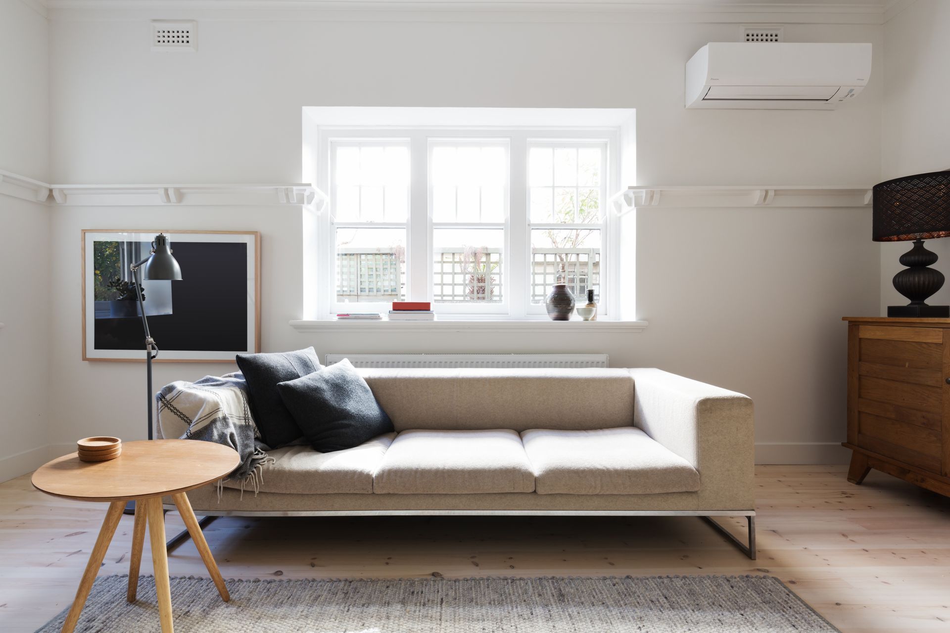 Bright white empty room with glossy floor, chandelier, and a doorway to a curtained back room