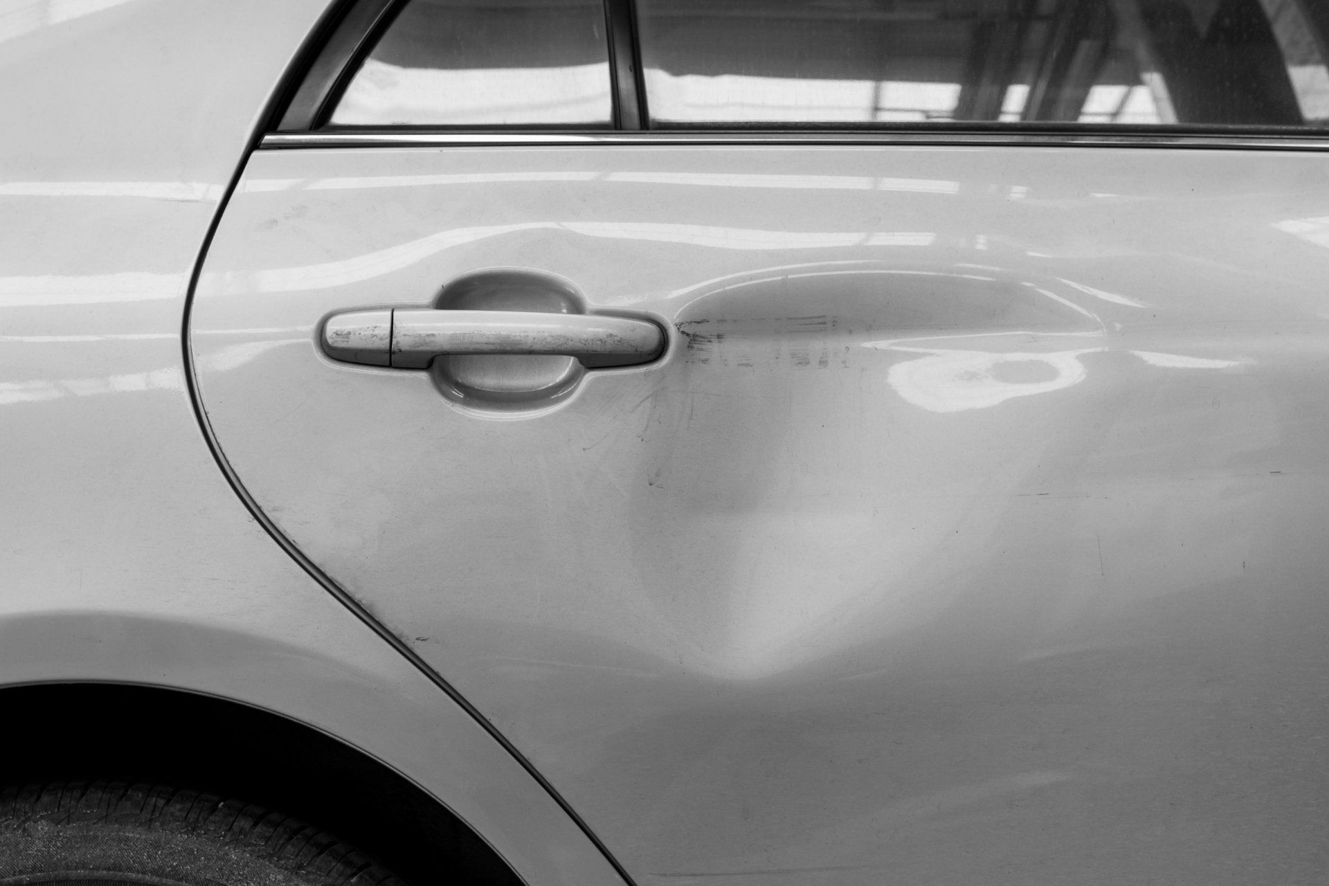The dents on the car door caused by the accident