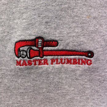 Red pipe wrench logo with the words “MASTER PLUMBING” on a gray shirt.