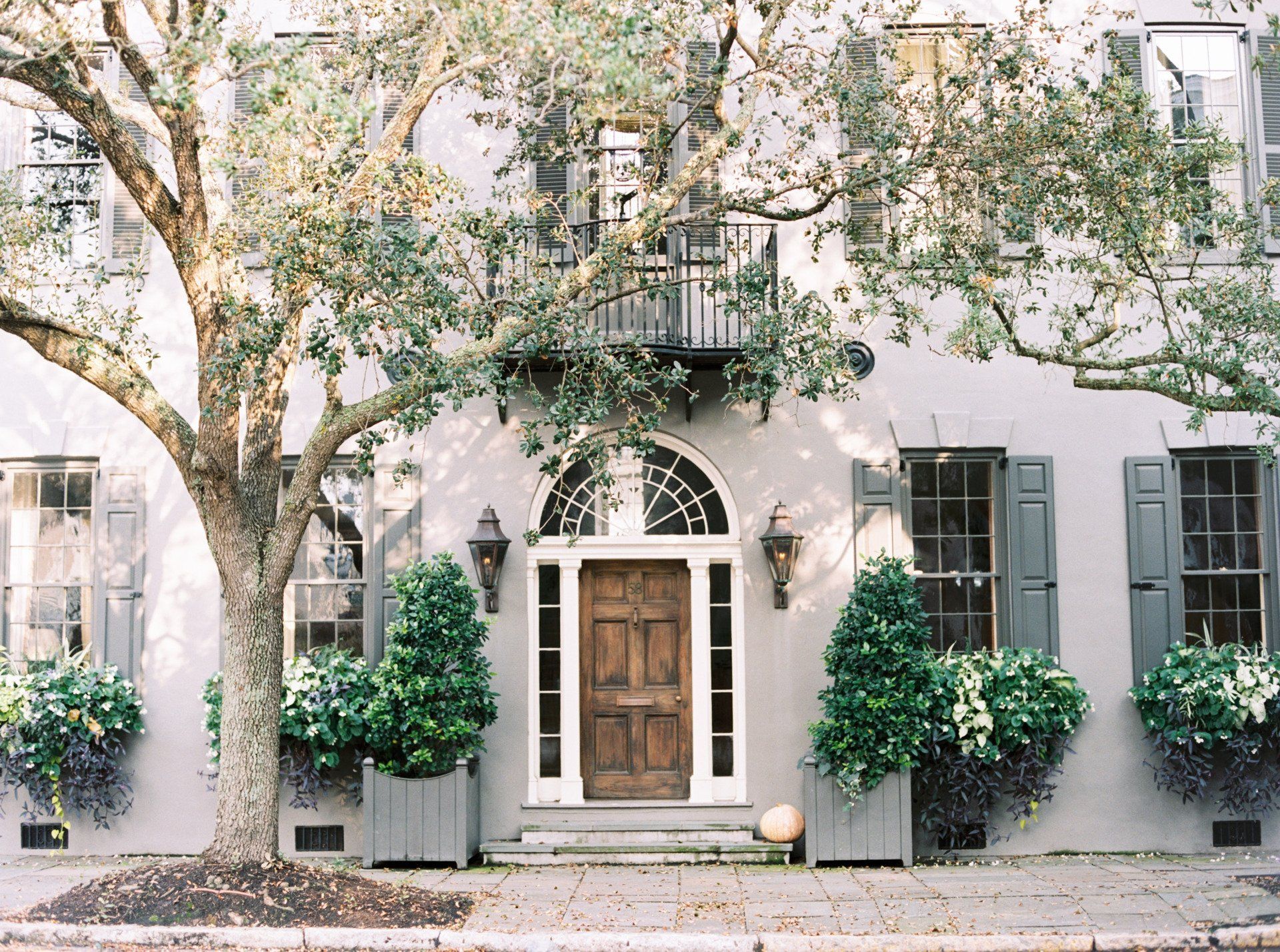 the front of a house with a tree in front of it .