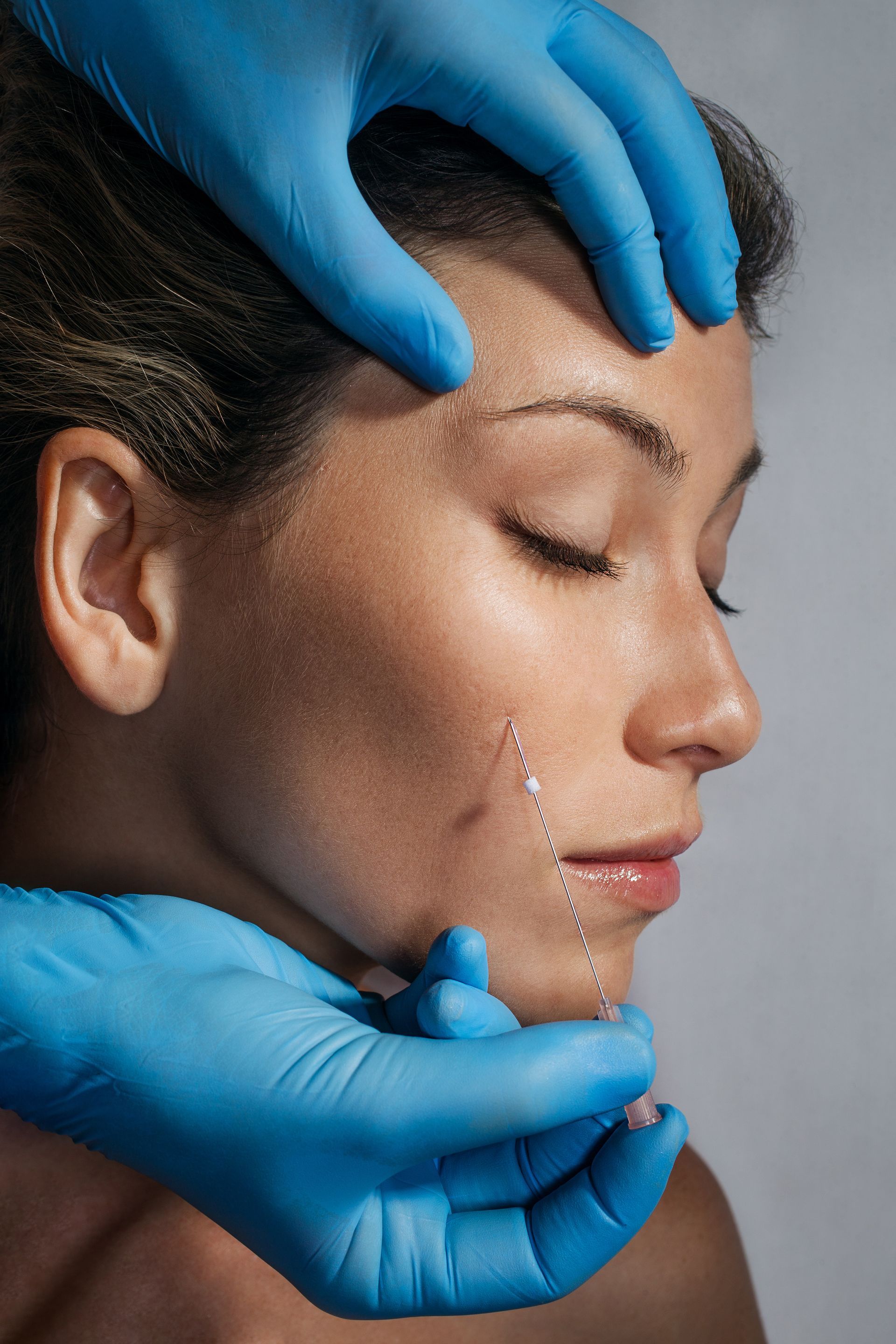 Provider performing scalp treatment for hair restoration and hair regeneration services