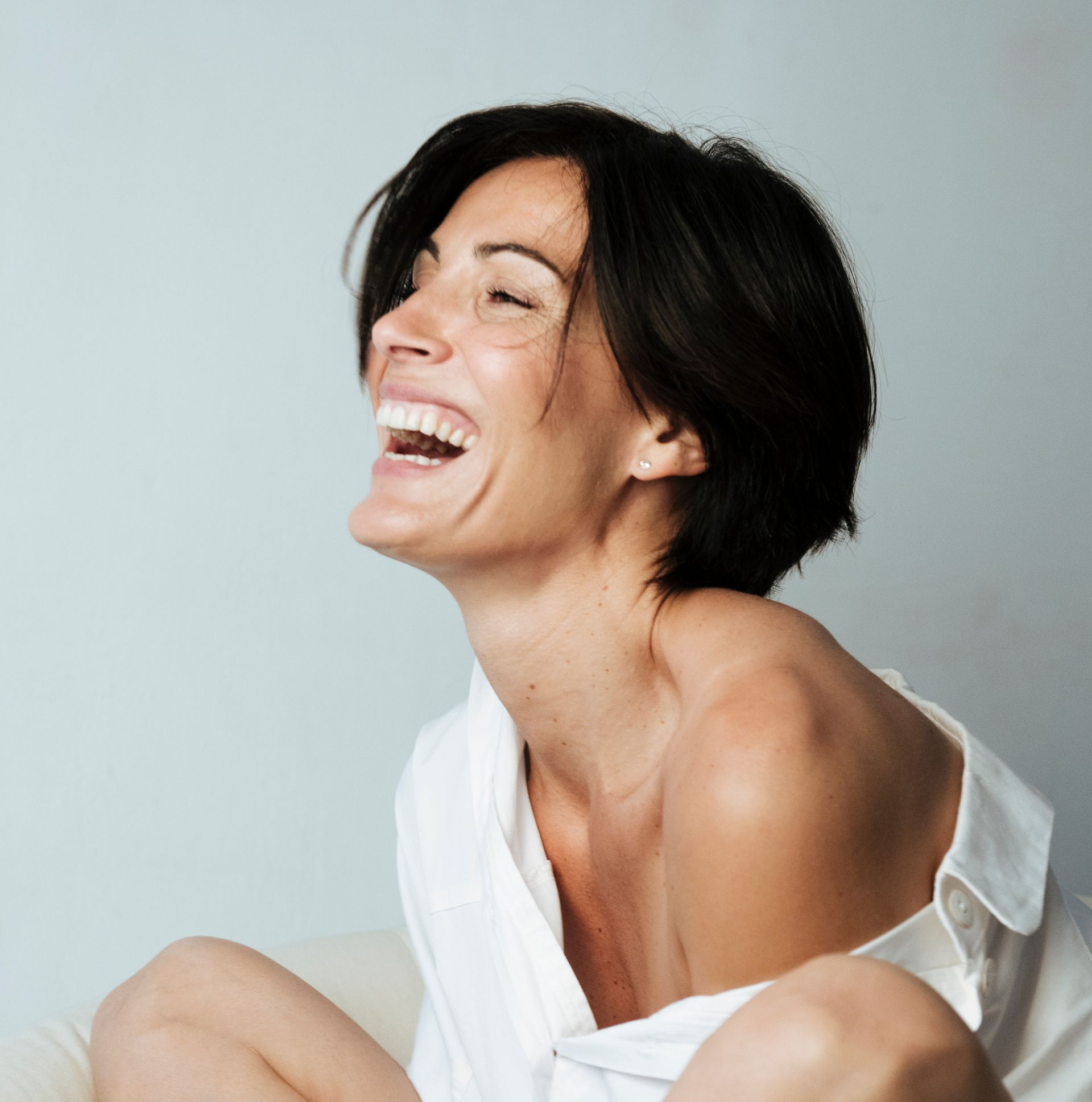 Smiling woman representing natural-looking aesthetic treatment results