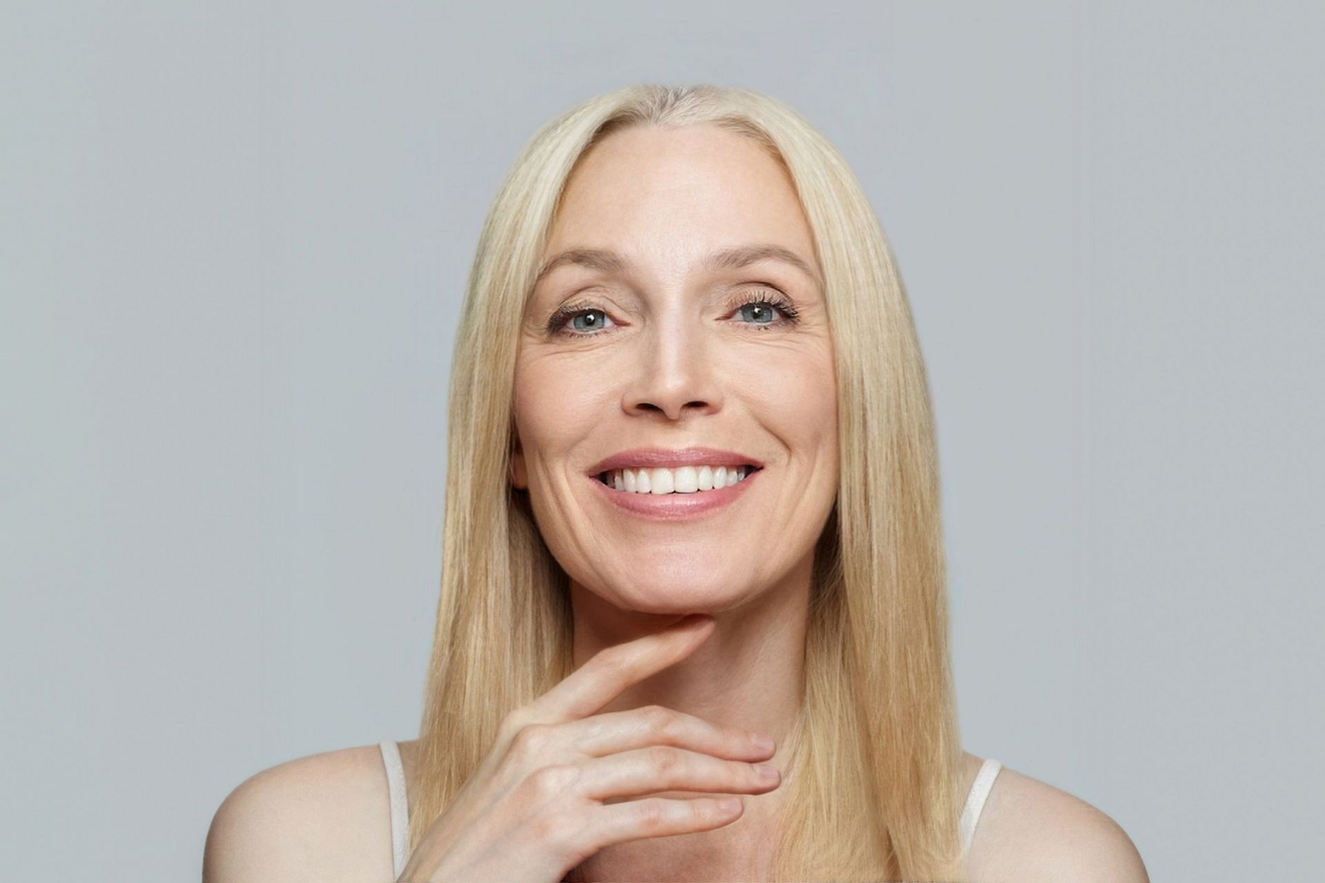 Smiling mature woman representing thread lift treatment candidate for natural facial rejuvenation