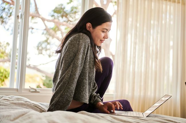 Woman using laptop for virtual medical consultation with CYP Medical Services