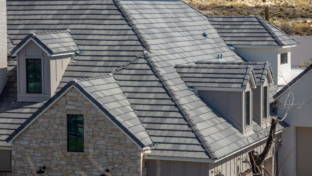 Boerne TZ — San Antonio, TX — Alexander’s Roofing Flat tile roof on a stone Texas Hill Country home — roofing services in Llano, TX