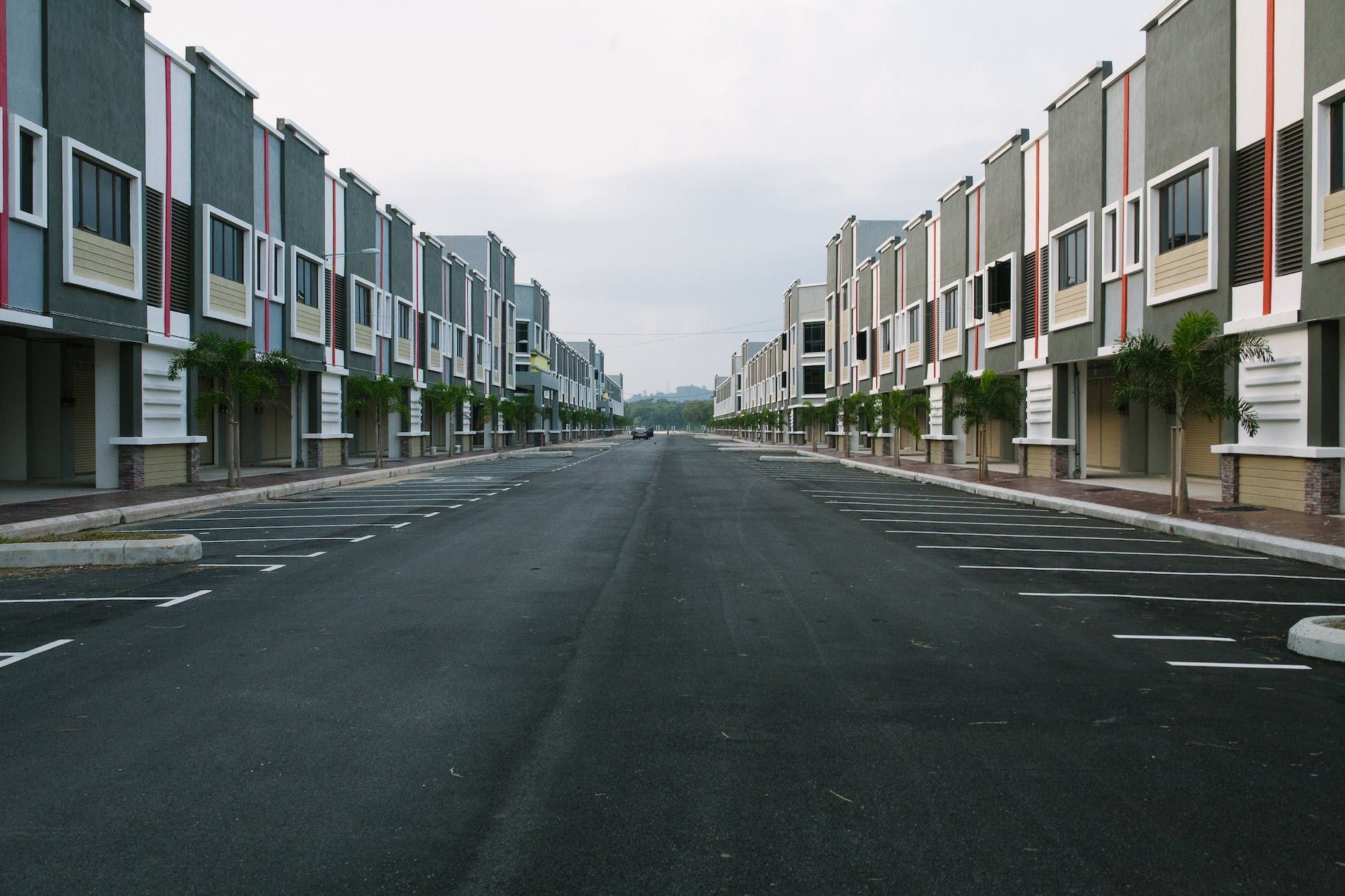 An empty street with a row of buildings on both sides