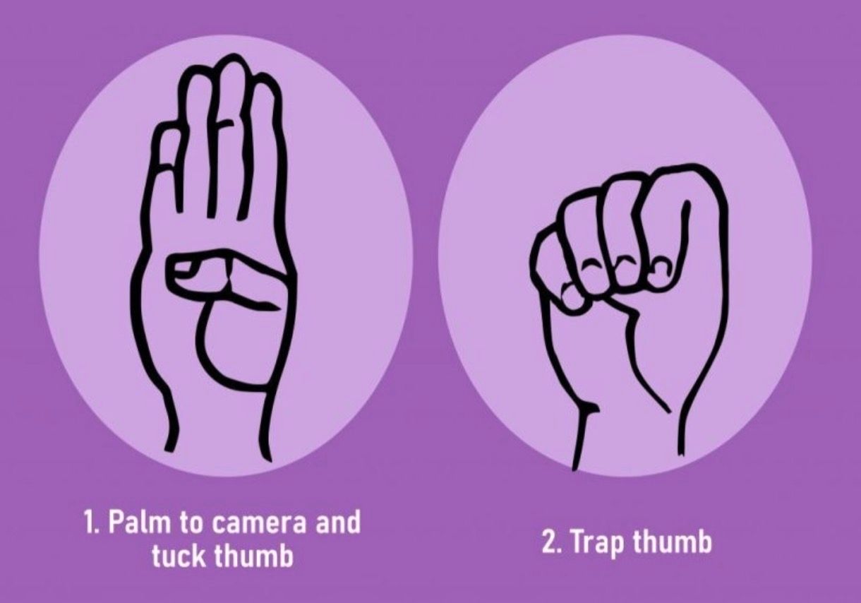 Palm to camera and tuck thumb and trap thumb on a purple background