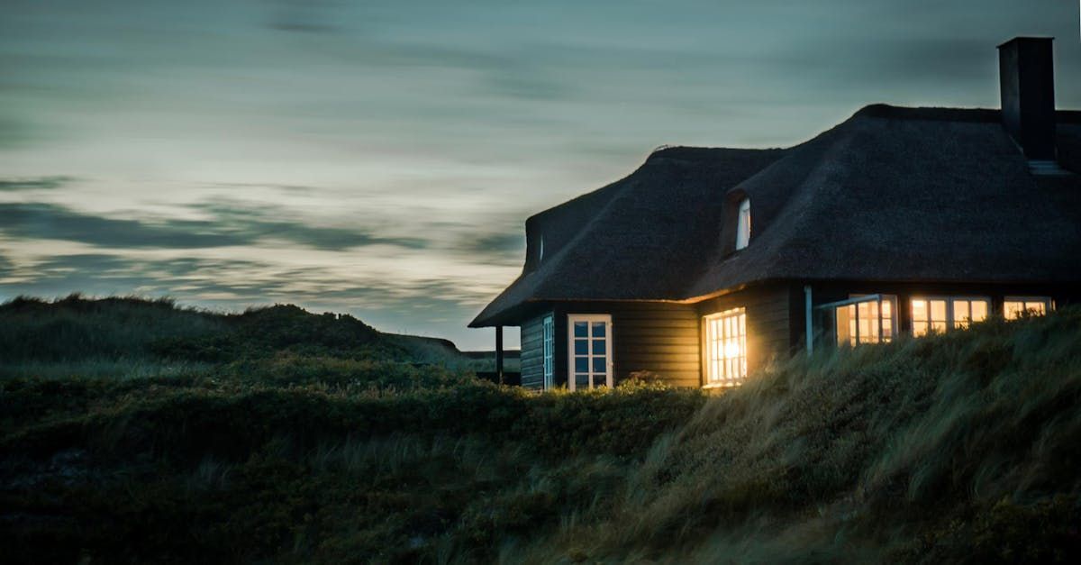 A house is sitting on top of a hill at night.