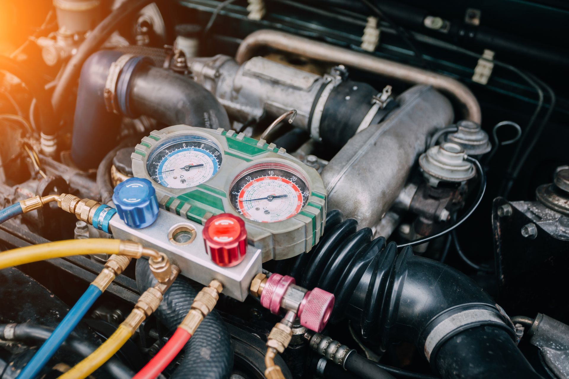A close up of a car engine with a bunch of gauges on it.