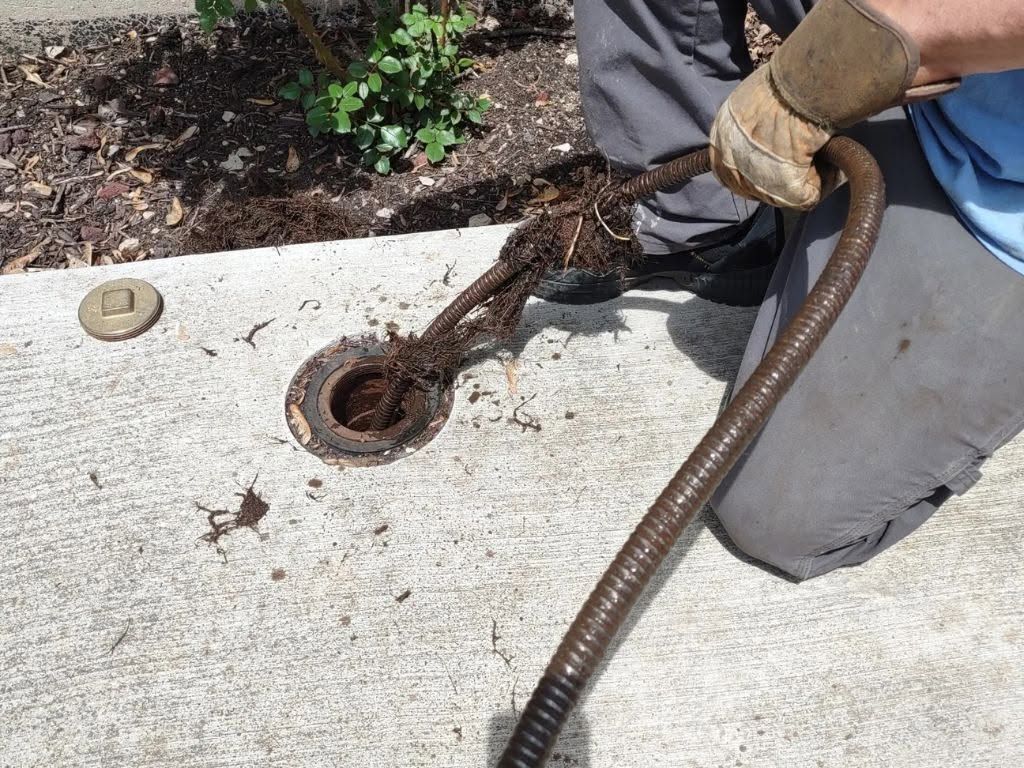 Leaking metal pipe joint with water spraying onto a blue background