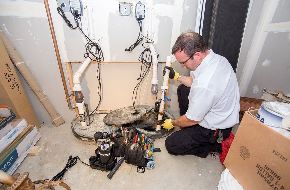 Hands installing or repairing a toilet in a bathroom