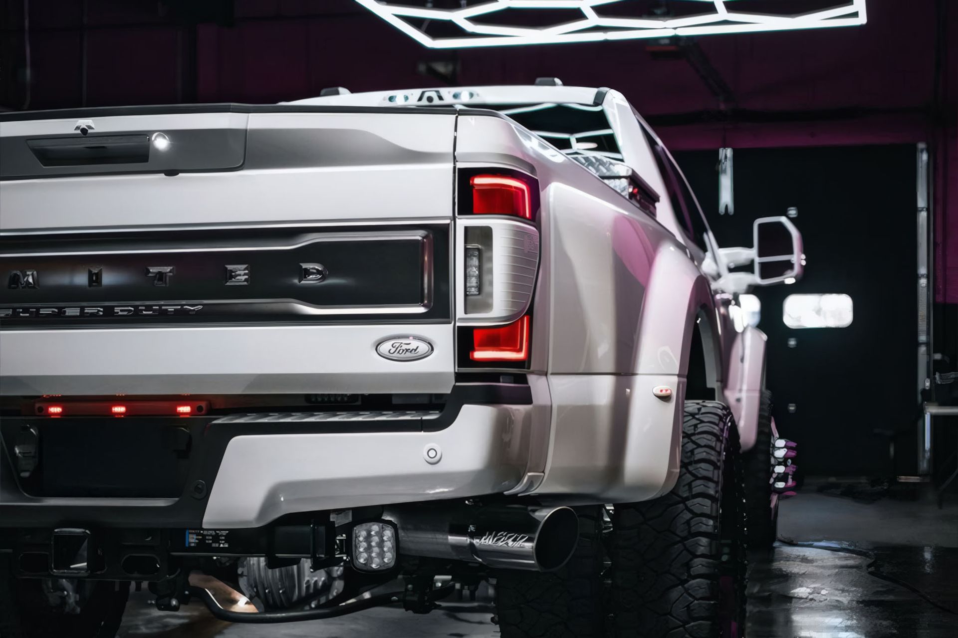 Rear view of a silver Ford pickup truck in a dimly lit garage