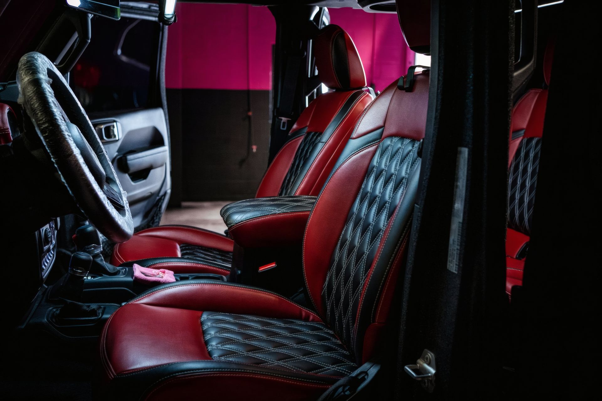 Red-and-black custom car interior with quilted seats and racing-style trim