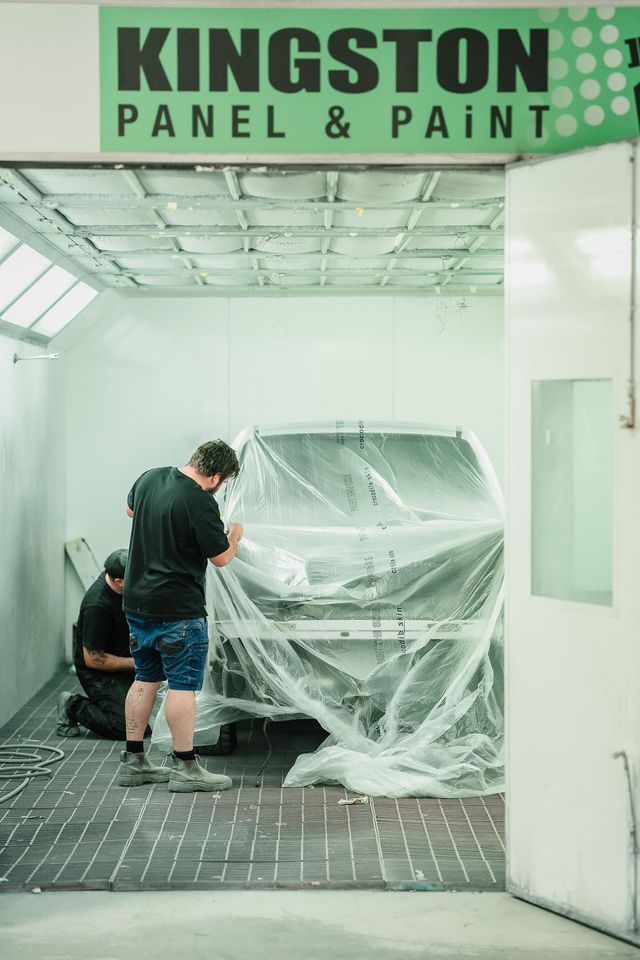Person Wrapping a Car in Plastic at Kingston Panel & Paint Shop — Kingston Panel & Paint in Huntingfield, TAS