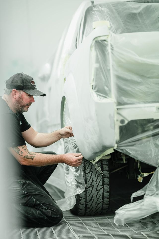 Mechanic Spraying Paint on the Front Fender — Kingston Panel & Paint in Huntingfield, TAS