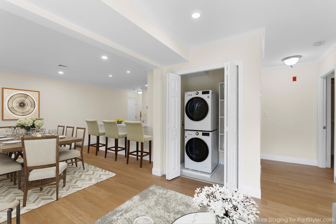Laundry closet with stacked washer and dryer in an open living/dining space.