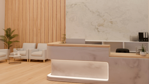 Empty clinic room with a bed, sink, cabinets, and mirror in warm beige tones