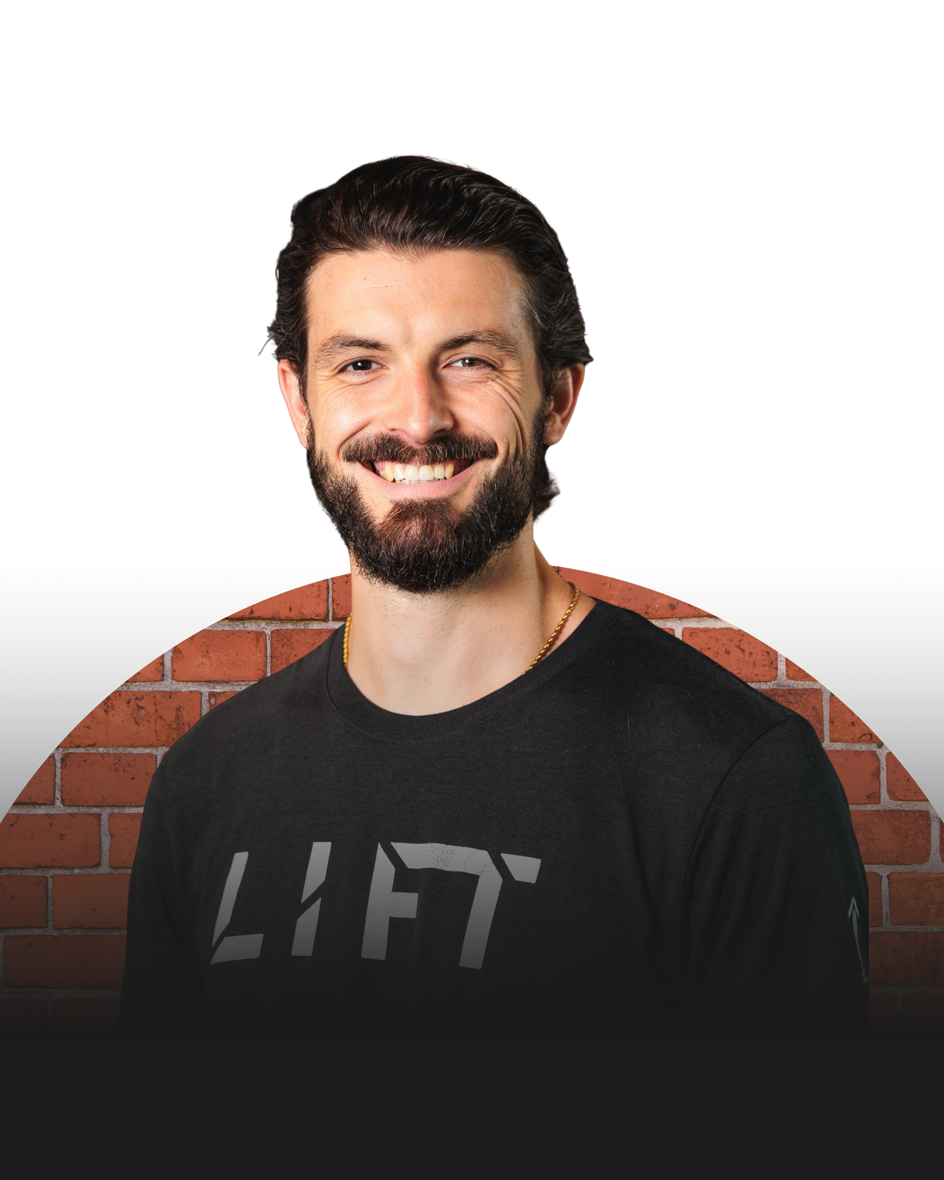 Man with beard smiles, wearing a black shirt with