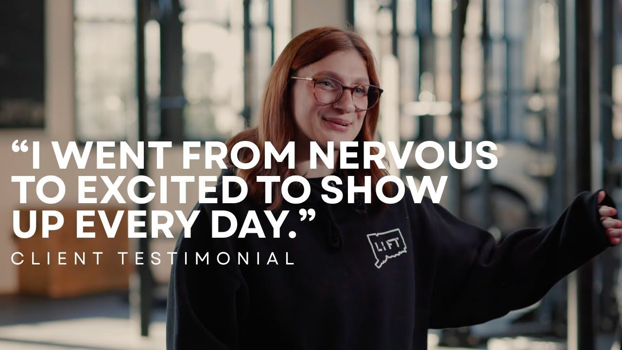 Smiling woman in a black coat stands in a modern office with quote text: “I went from nervous to excited to show up every day.”