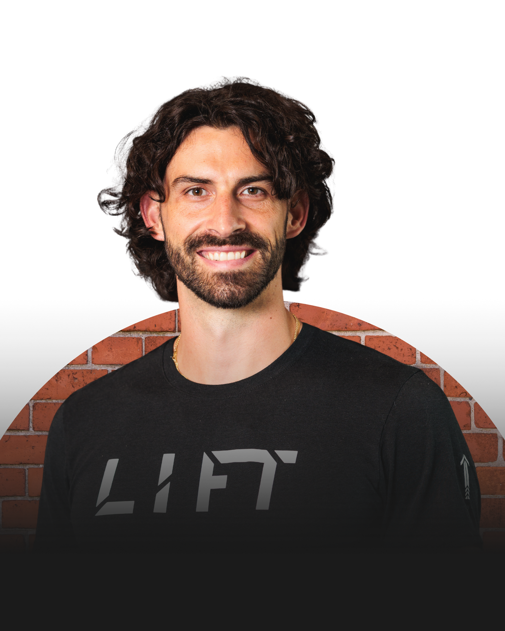 Smiling man with dark curly hair wearing a black