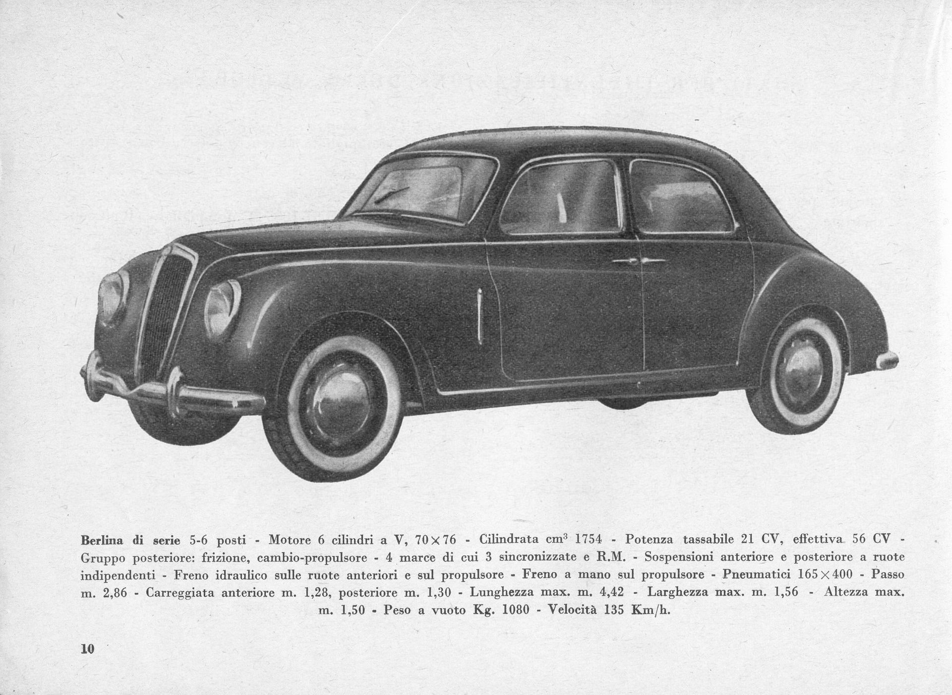 Black and white photo of a dark sedan with white wall tires.