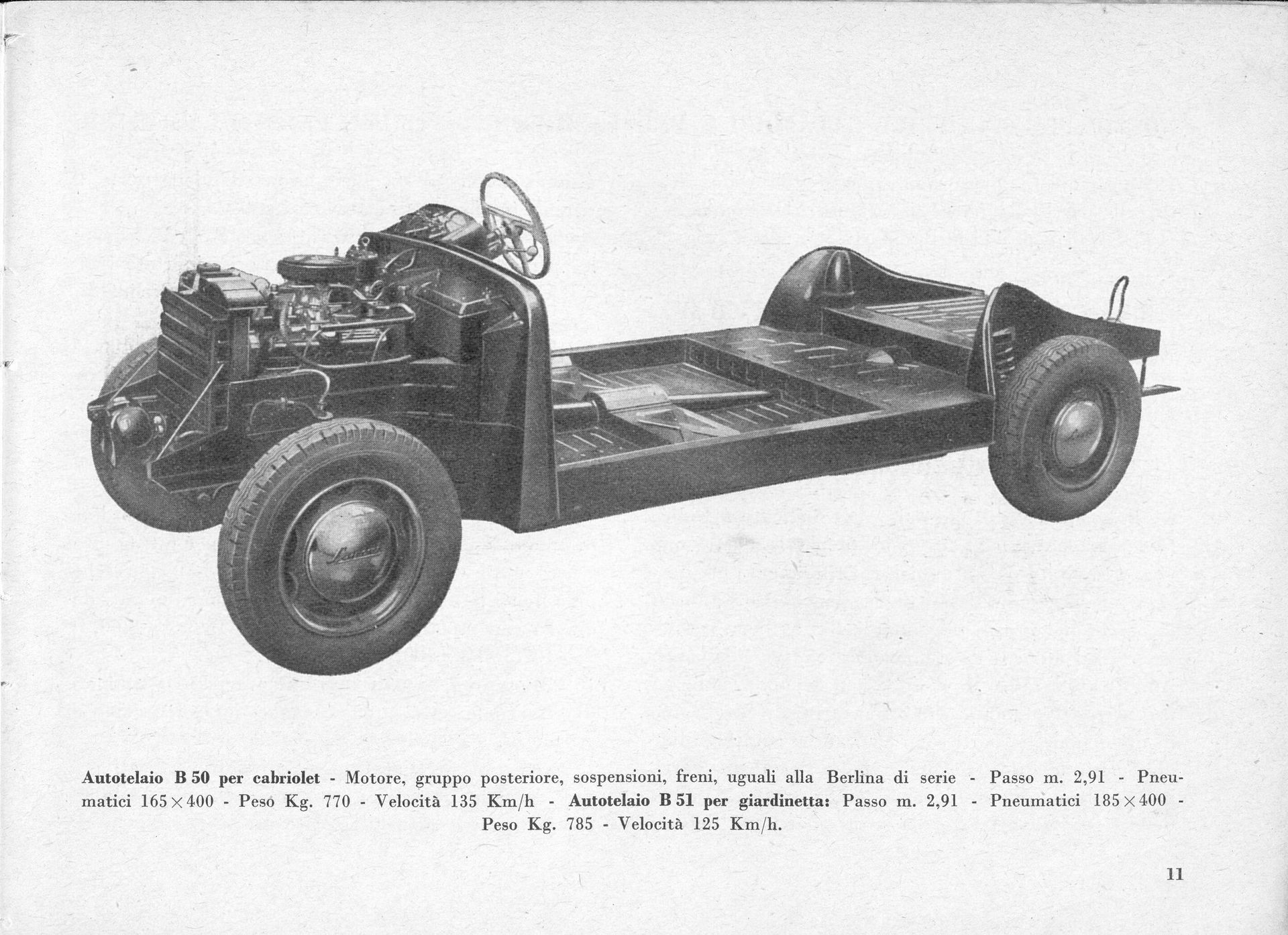 Chassis of a vintage car, showing the engine, steering wheel, and body frame.