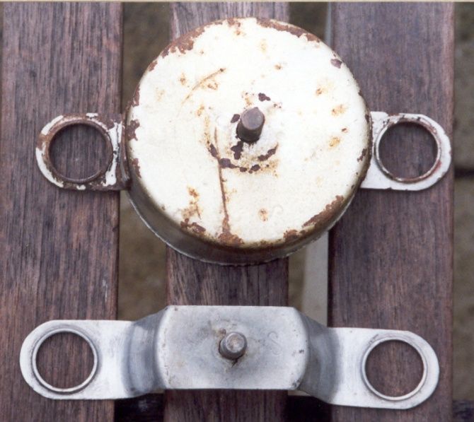 A rusty metal object is sitting on a wooden table