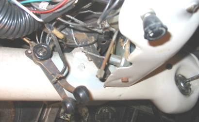 Dashboard interior with wires and levers, likely an older vehicle.