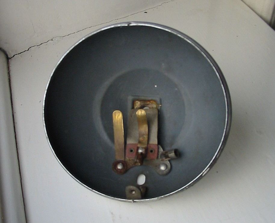 Gray-painted metal bell with internal copper contacts.