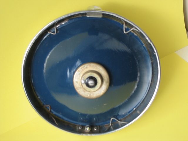Blue reflector inside a silver headlight housing, with a circular bulb holder in the center.