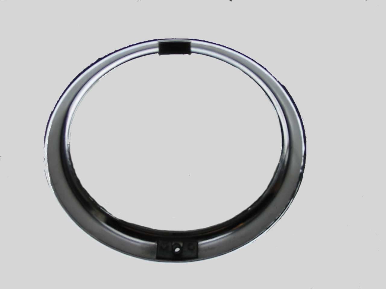 Chrome headlight bezel with two black mounting tabs.