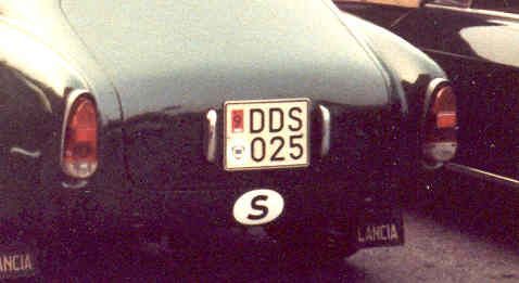 Rear of a black vintage Lancia car with Swiss license plate and 