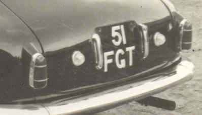 Rear bumper and license plate of a classic car, black and chrome, with registration 
