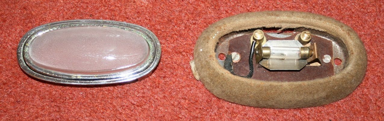 Two oval automotive lights: one with glass lens, the other with light housing and electrical connections.