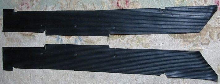 Two black, rectangular pieces with angled ends, possibly parts of something.