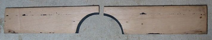 Two rectangular wooden pieces, separated by a semi-circular cutout.