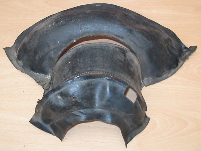 Black rubber elbow pipe joint on a wooden surface.